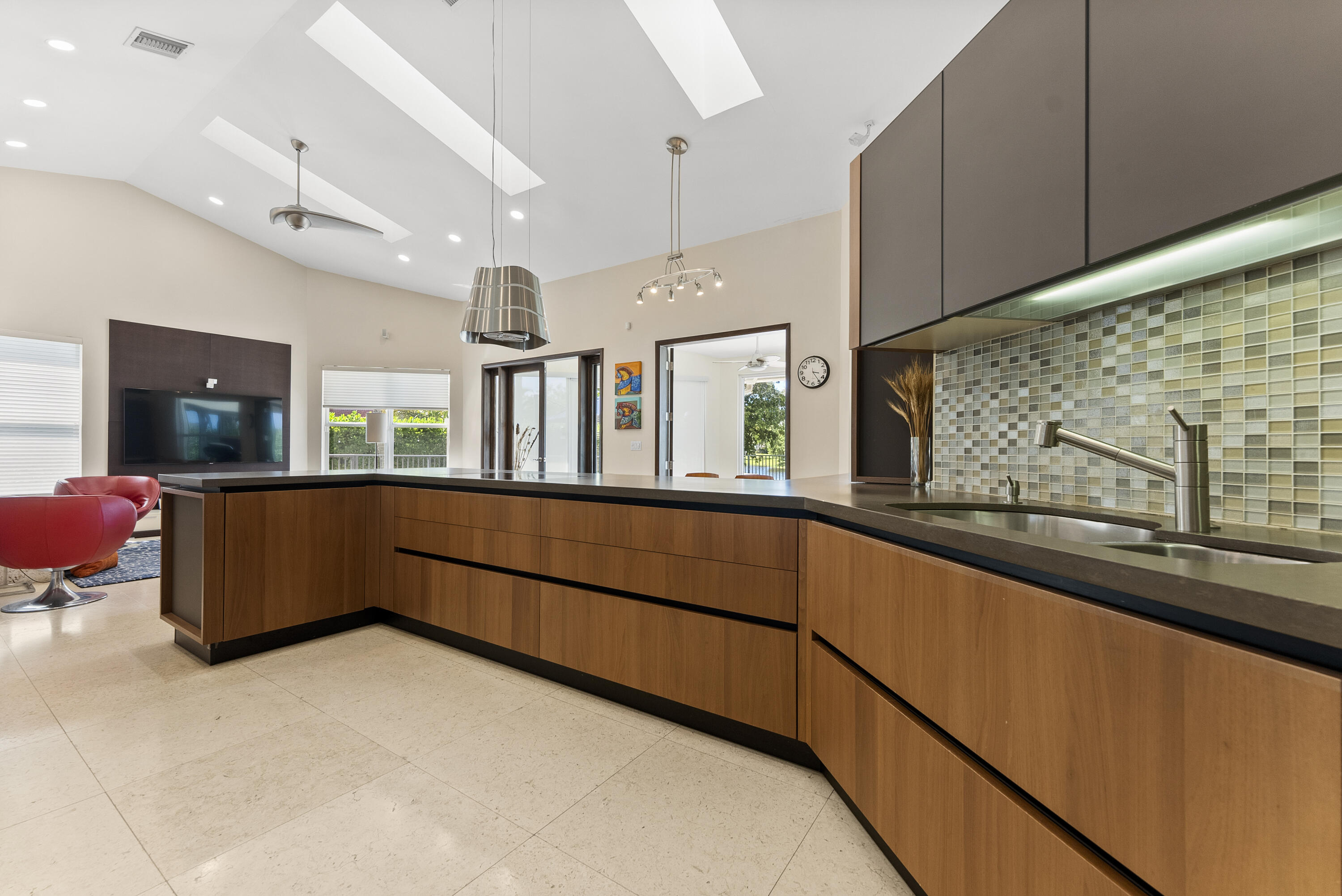 2245 Southwest 16th Place Boca Raton, FL 33486 - Photo 12 of 40 a kitchen with stainless steel appliances kitchen island granite countertop a sink and cabinets