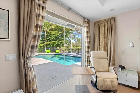 a view of swimming pool with a patio and a garden