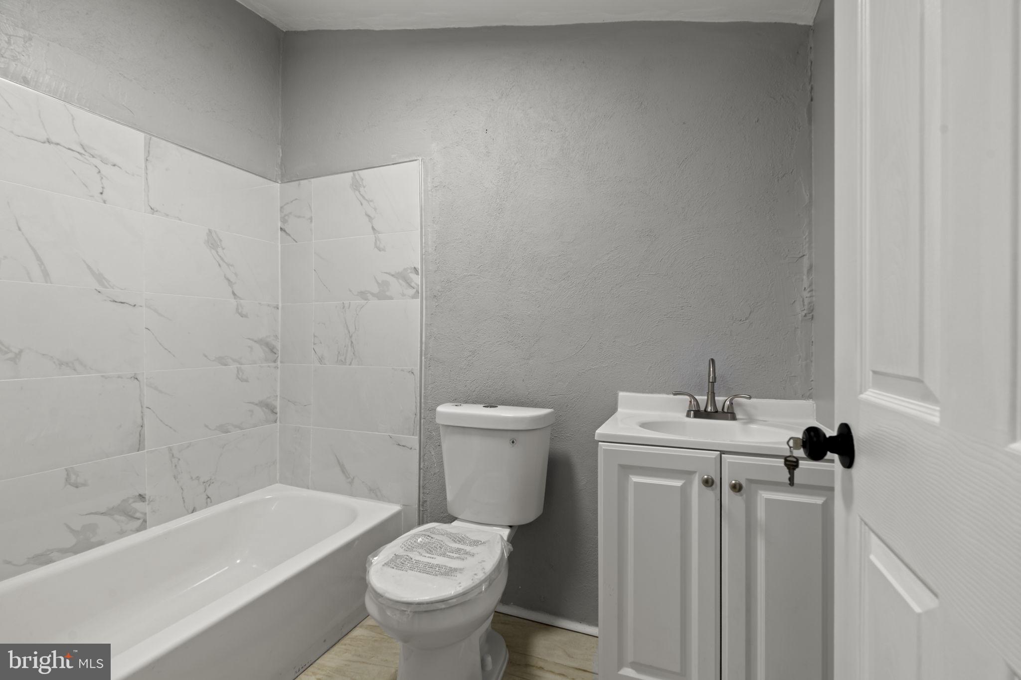 2314 West 3rd Street Chester, PA 19013 - Photo 16 of 32 a bathroom with a sink a toilet and shower