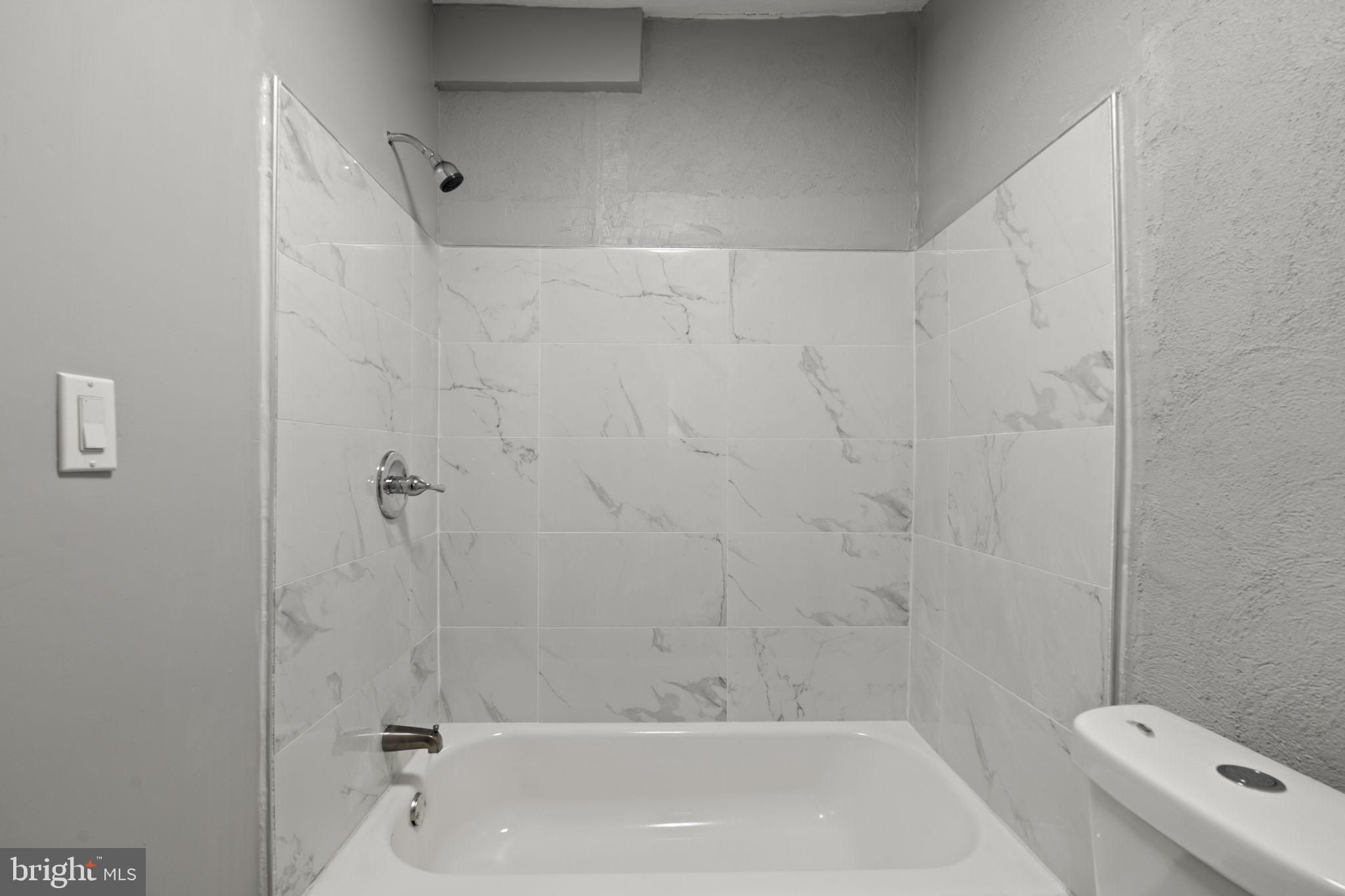 2314 West 3rd Street Chester, PA 19013 - Photo 17 of 32 a bathroom with a bathtub and toilet