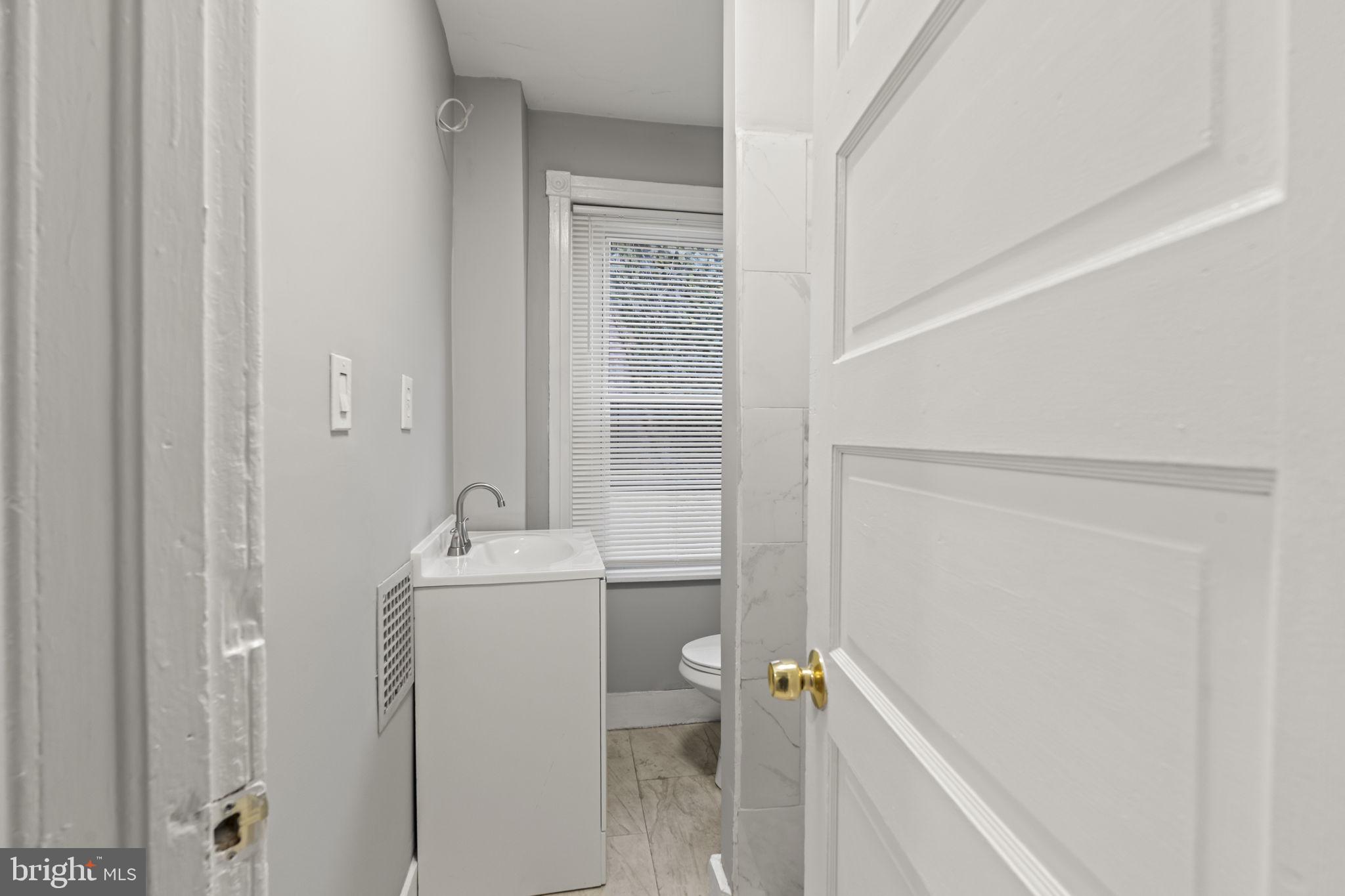 2314 West 3rd Street Chester, PA 19013 - Photo 22 of 32 a bathroom with a sink a toilet and shower