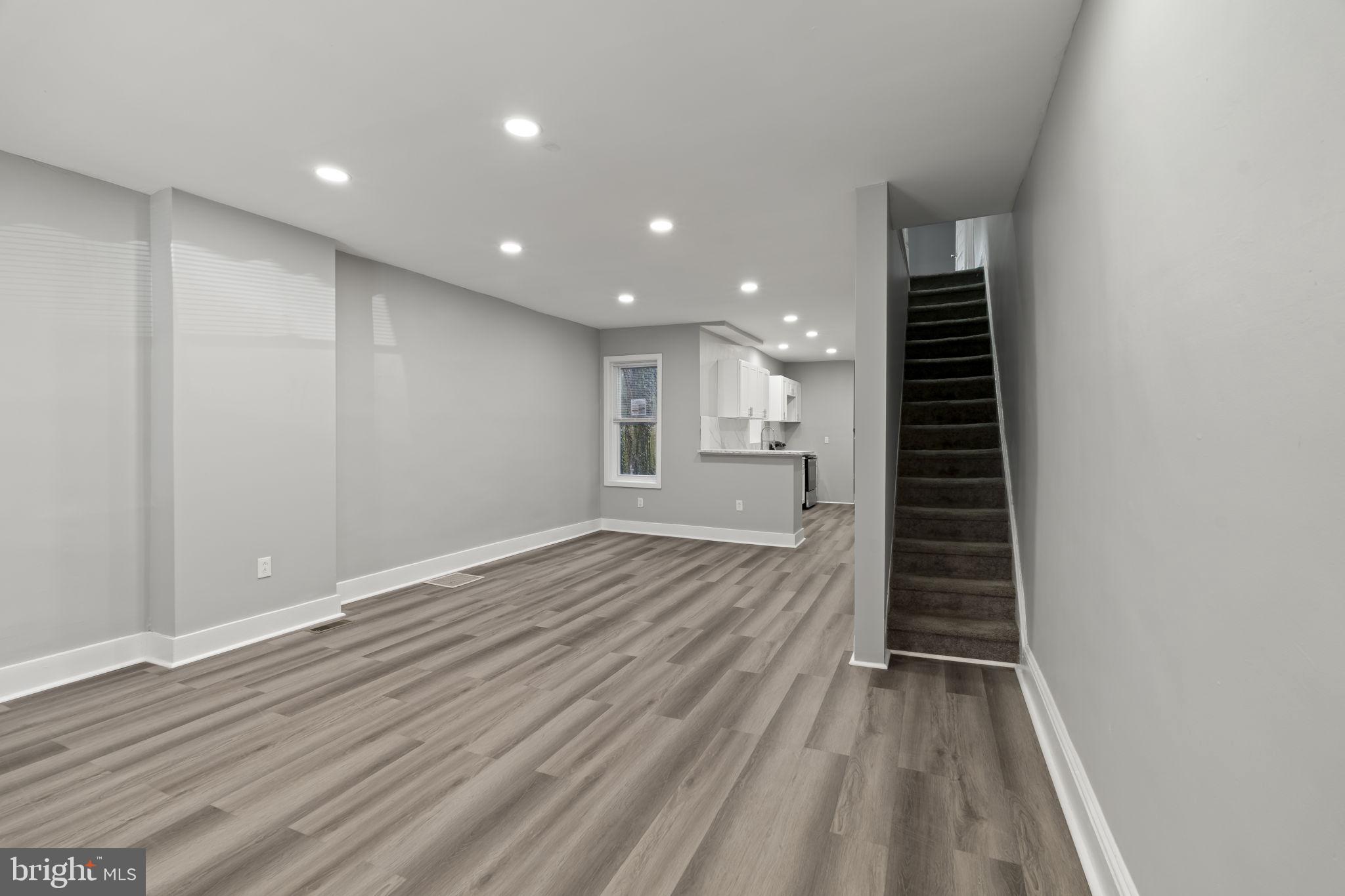 2314 West 3rd Street Chester, PA 19013 - Photo 6 of 32 an empty room with wooden floor and windows