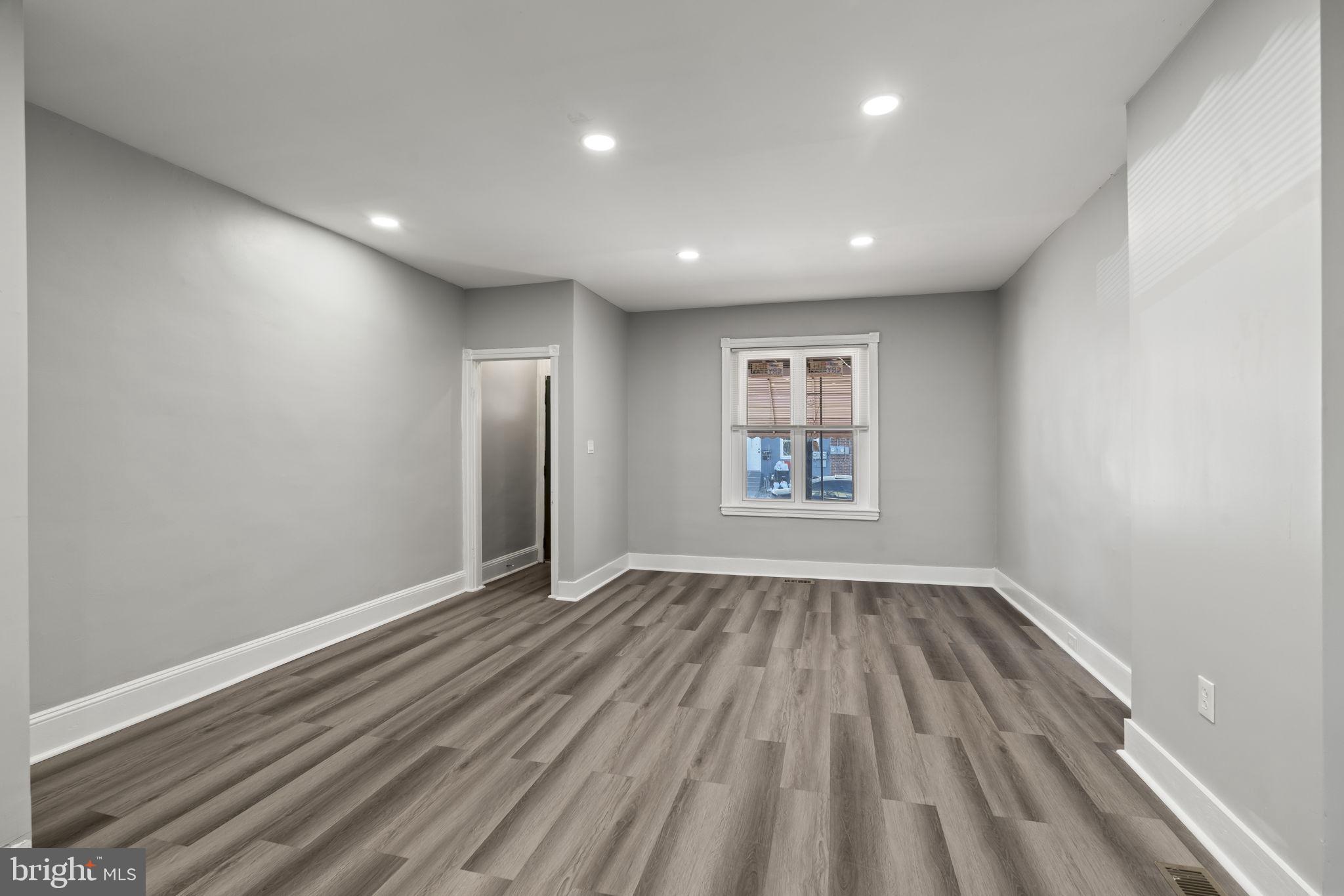 2314 West 3rd Street Chester, PA 19013 - Photo 9 of 32 a view of an empty room with wooden floor and a window