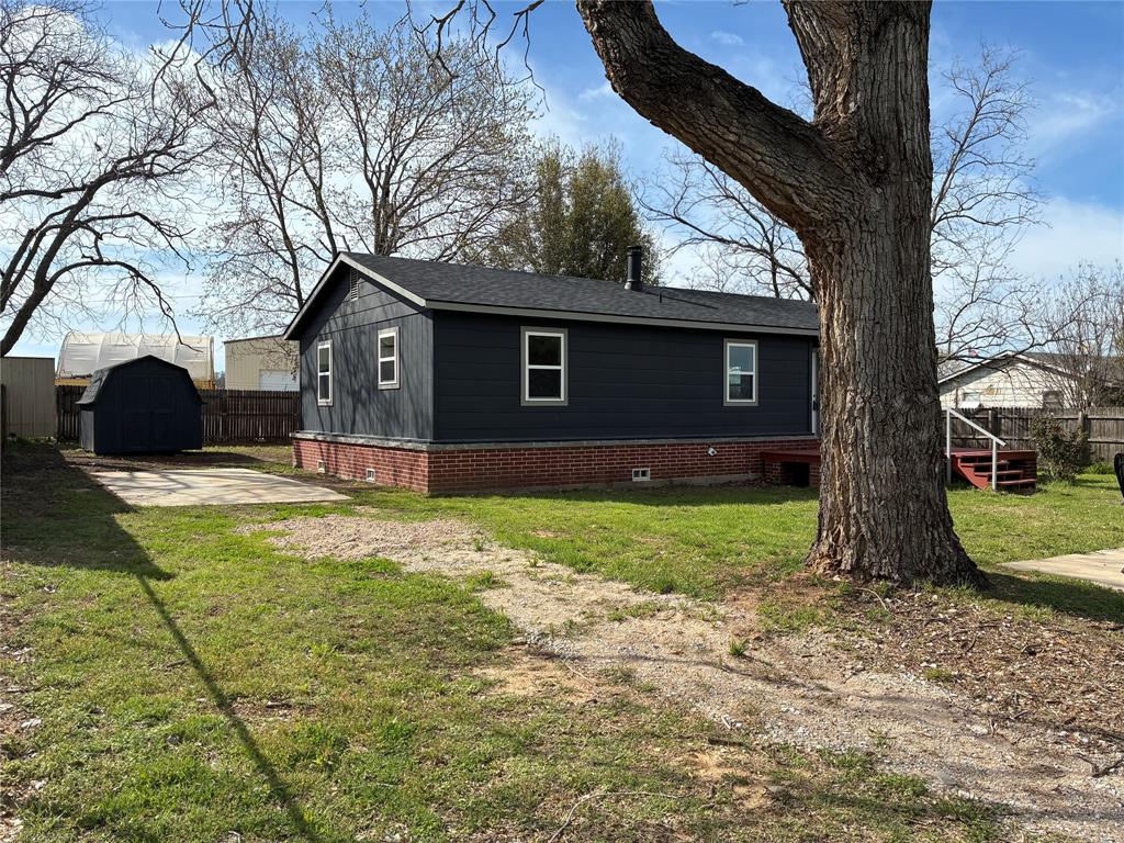 5066 East Highway 199 Springtown, TX 76082 - Photo 2 of 15 View of side of home with a shed and roof with shingles