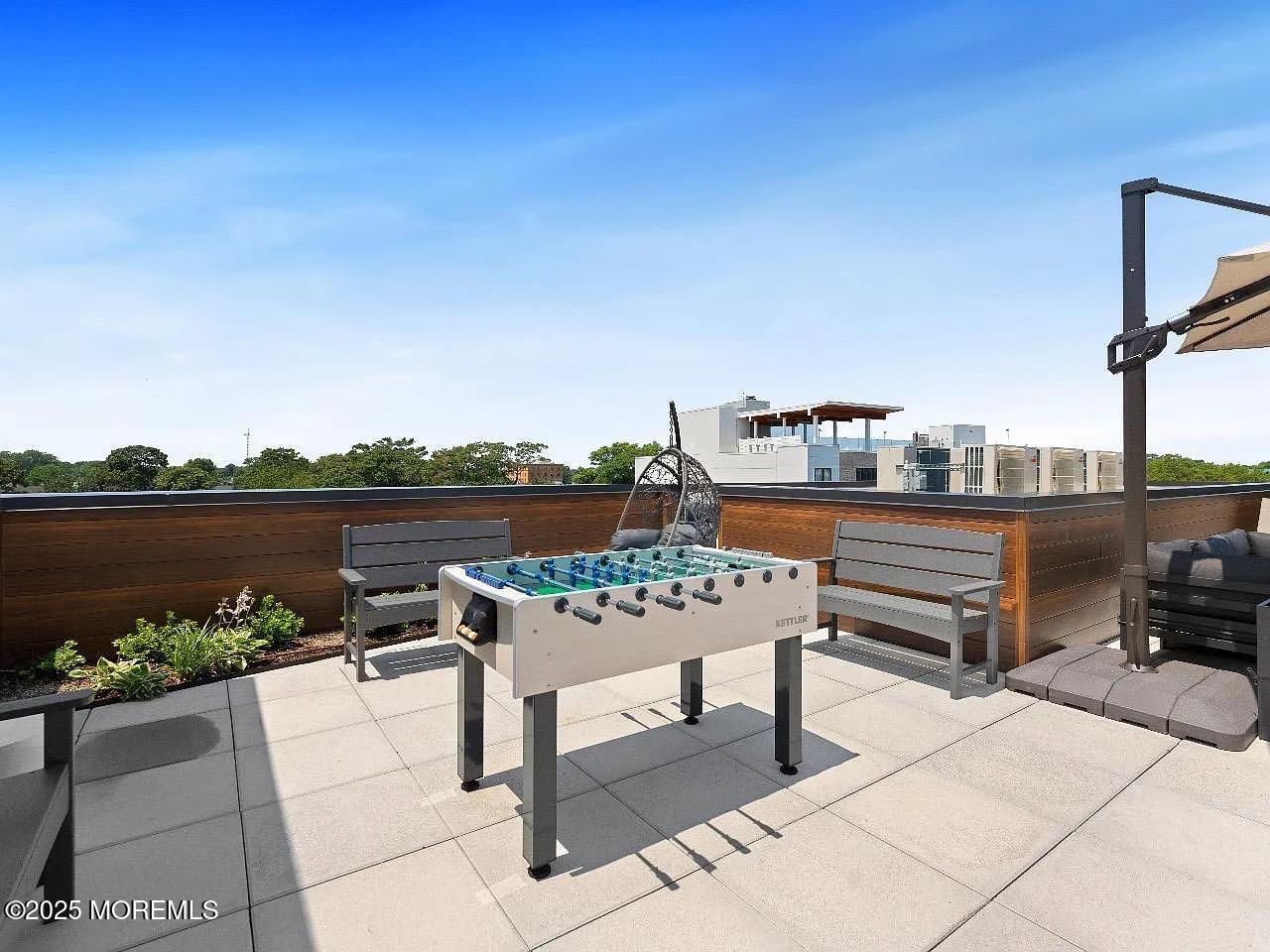 27 3rd Avenue, Unit 304 Long Branch, NJ 07740 - Photo 23 of 28 a view of a terrace with couches and wooden floor