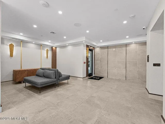 a room with a sink dishwasher and a dining table with wooden floor