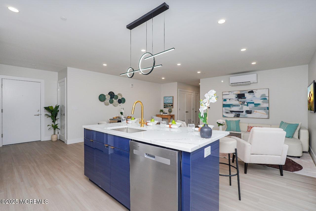 27 3rd Avenue, Unit 304 Long Branch, NJ 07740 - Photo 8 of 28 a room with a sink dishwasher and a dining table with wooden floor