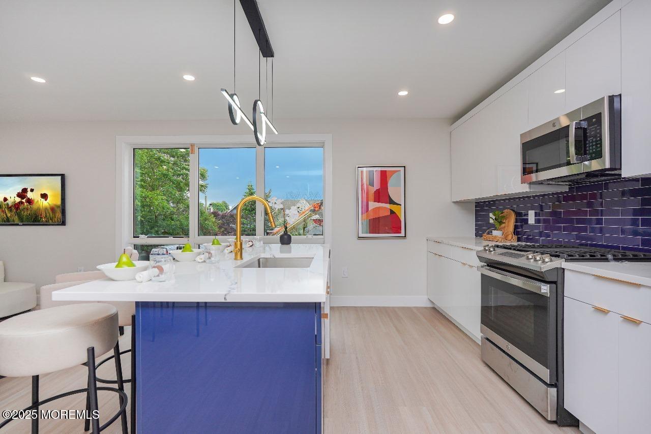 27 3rd Avenue, Unit 304 Long Branch, NJ 07740 - Photo 9 of 28 a kitchen with a sink cabinets and window