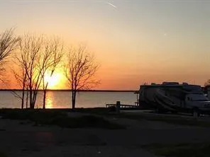 a view of a lake in between two of trees