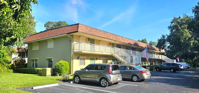 a view of a cars park in front of a building