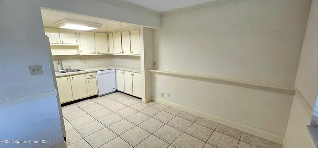 a view of a kitchen with white cabinets and a stove top oven