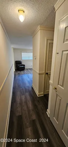 a view of a kitchen from a hallway