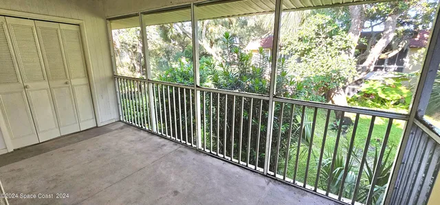 a view of a balcony with wooden floor