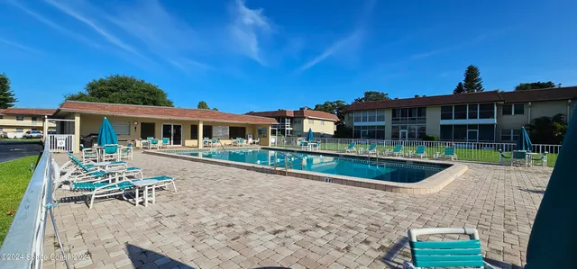 a view of house with a yard balcony and seating space