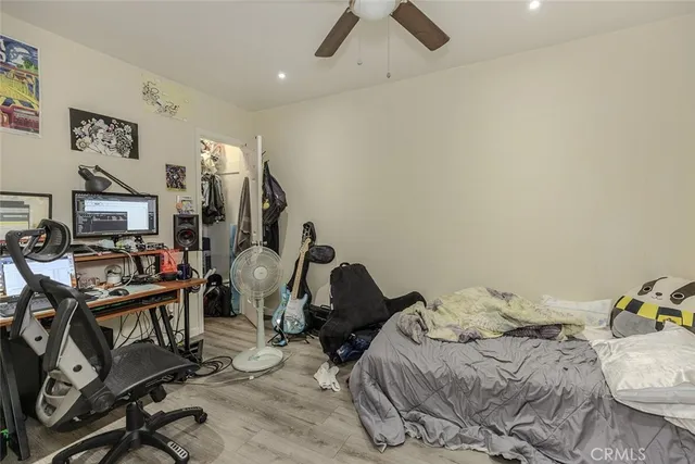 a front view of small house with yard outdoor seating and barbeque oven