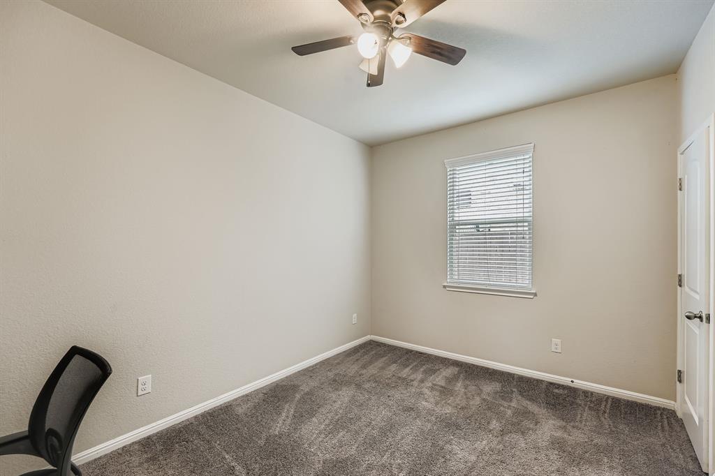 429 Rusk Bluff Avenue Leander, TX 78641 - Photo 11 of 24 An inviting room with plush carpeting and a ceiling fan, offering a comfortable personal retreat.