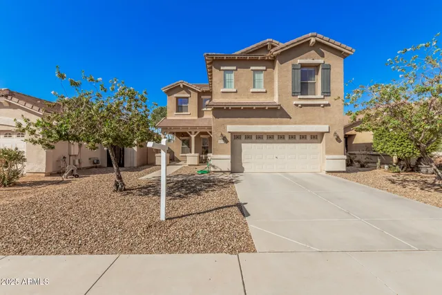 a view of a white house with a yard
