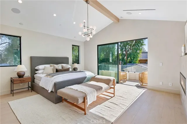 a spacious bathroom with a double vanity sink a large mirror and a shower