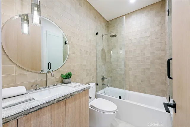 a bathroom with a toilet a sink and a mirror