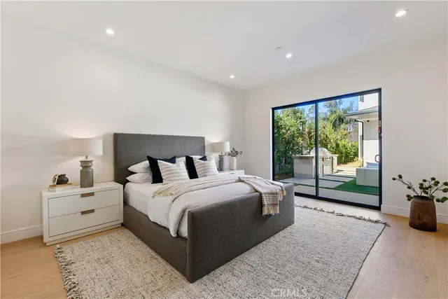 a bedroom with a bed and painting on the wall