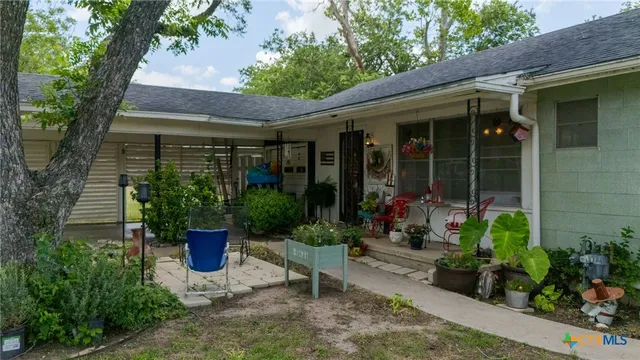 a view of a house with sitting area and garden