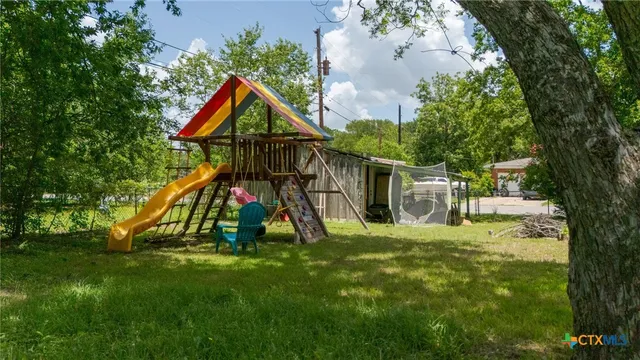 a view of playground with a slide and swing