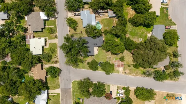 an aerial view of residential houses with yard