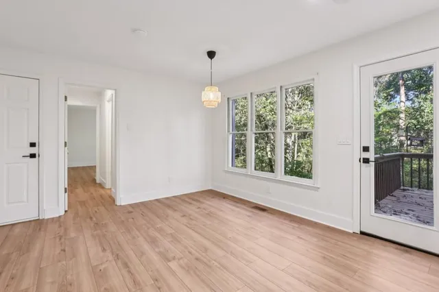 a view of a kitchen with a sink cabinets and wooden floor