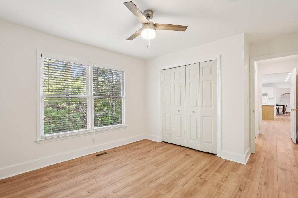 10630 Timberstone Road Alpharetta, GA 30022 - Photo 18 of 42 a view of an empty room with wooden floor and a window