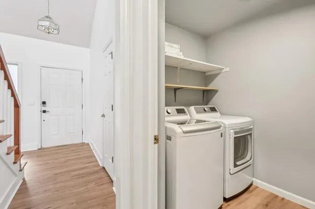 a view of staircase with railing and white walls