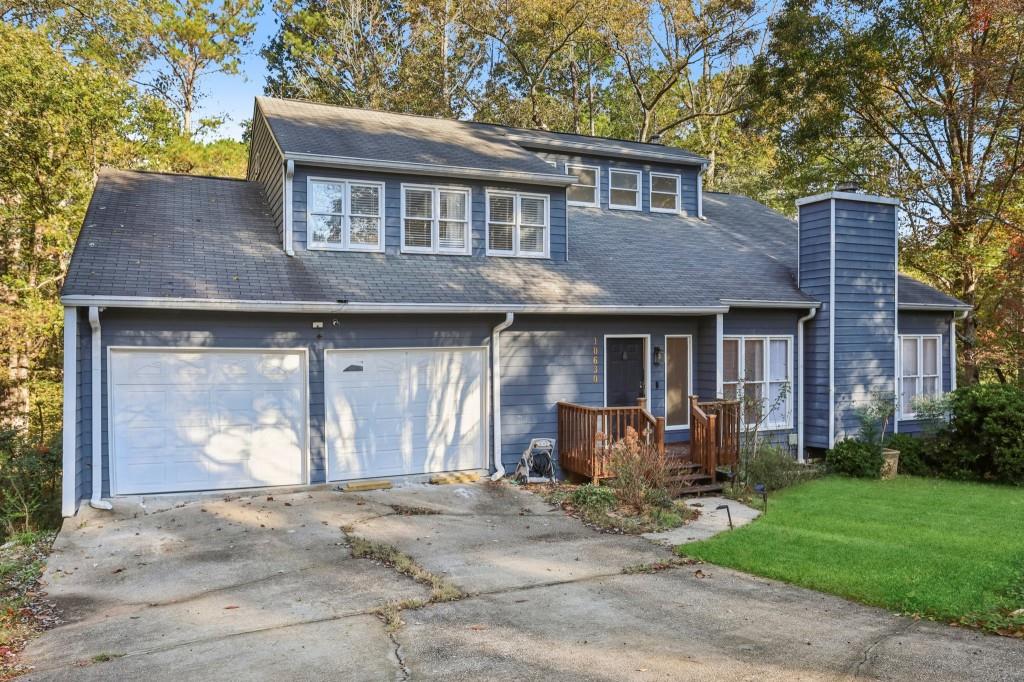 10630 Timberstone Road Alpharetta, GA 30022 - Photo 2 of 42 a front view of a house with garden