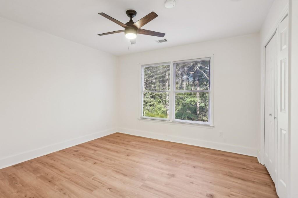 10630 Timberstone Road Alpharetta, GA 30022 - Photo 21 of 42 an empty room with wooden floor and windows