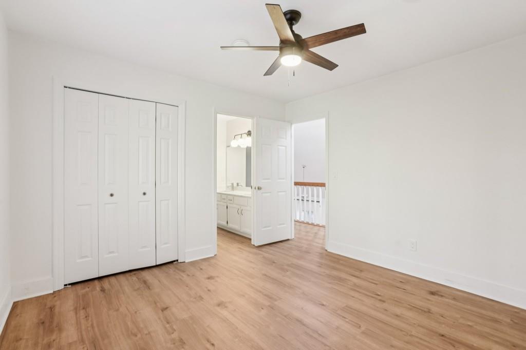 10630 Timberstone Road Alpharetta, GA 30022 - Photo 22 of 42 a view of a livingroom with wooden floor and a ceiling fan