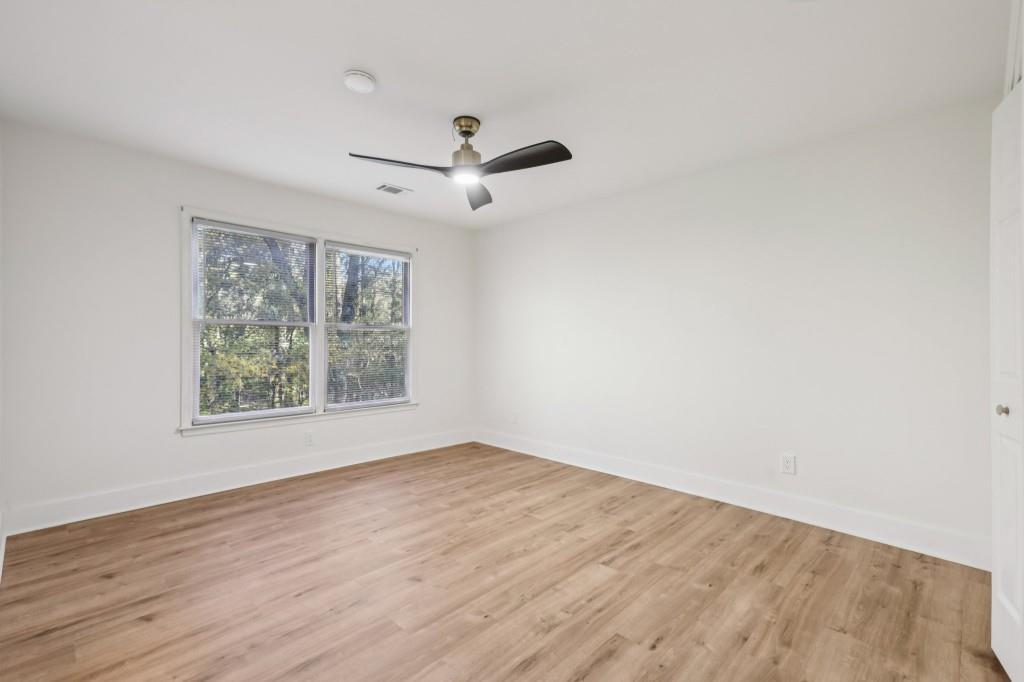 10630 Timberstone Road Alpharetta, GA 30022 - Photo 26 of 42 wooden floor in an empty room with a window
