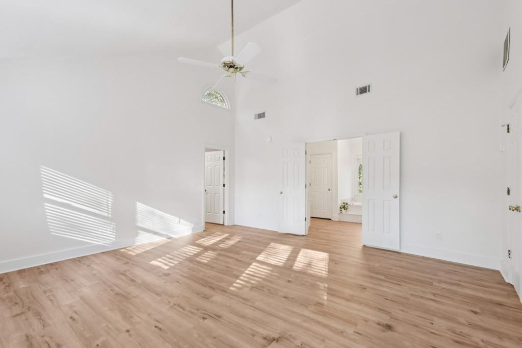 10630 Timberstone Road Alpharetta, GA 30022 - Photo 28 of 42 a view of a livingroom with wooden floor and kitchen space