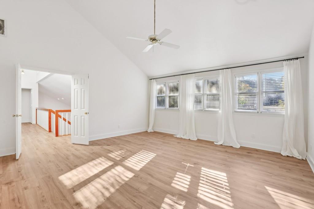 10630 Timberstone Road Alpharetta, GA 30022 - Photo 30 of 42 a view of an empty room with wooden floor and a window