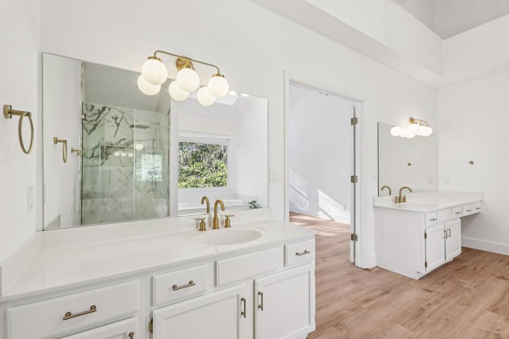 10630 Timberstone Road Alpharetta, GA 30022 - Photo 34 of 42 a bathroom with a sink a mirror and a large mirror