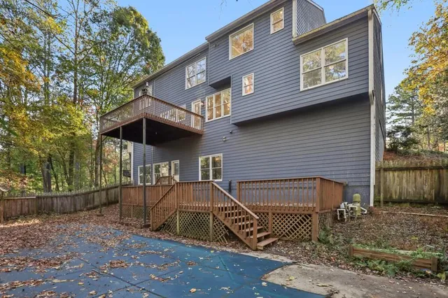 a balcony with wooden floor and trees