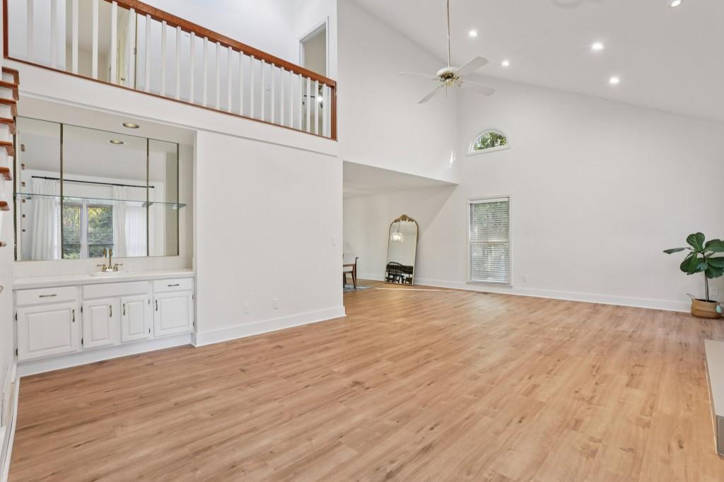 10630 Timberstone Road Alpharetta, GA 30022 - Photo 4 of 42 a view of empty room with wooden floor and fan