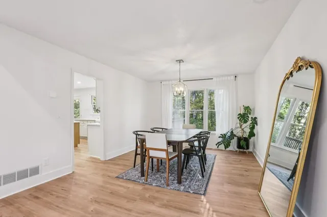 a view of a dining room with furniture window and wooden floor
