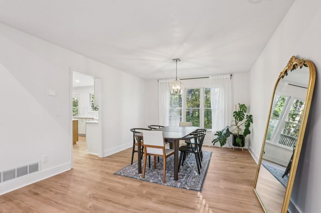 10630 Timberstone Road Alpharetta, GA 30022 - Photo 7 of 42 a view of a dining room with furniture window and wooden floor