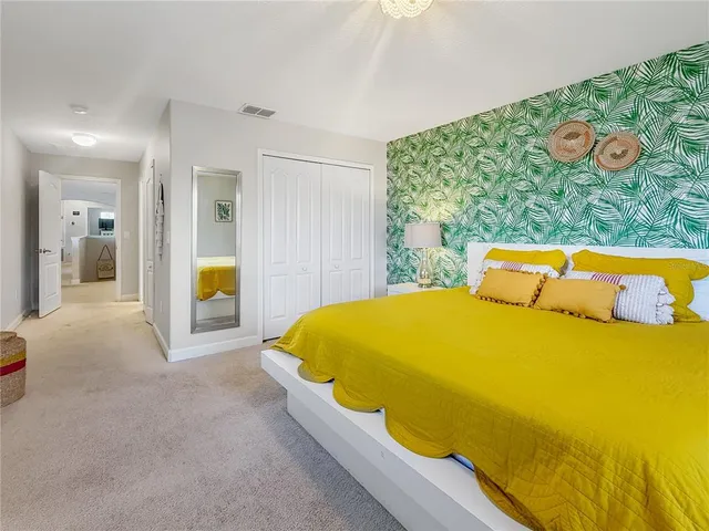 a bed sitting in a bedroom next to a window