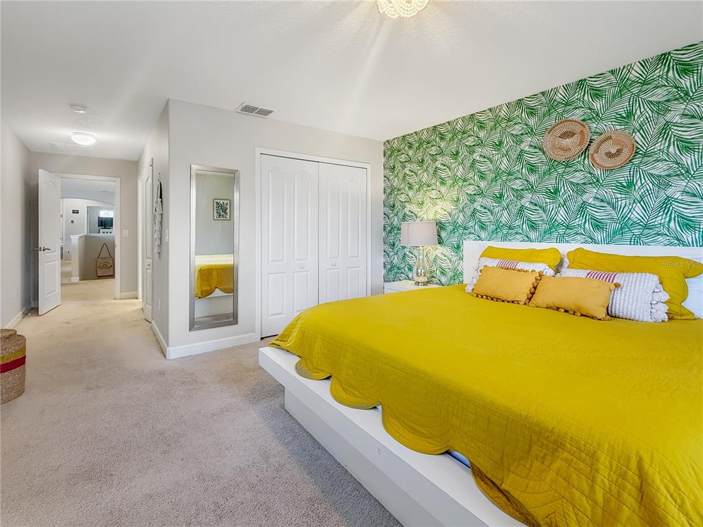 2942 Buccaneer Palm Road Kissimmee, FL 34747 - Photo 14 of 39 a bed sitting in a bedroom next to a window