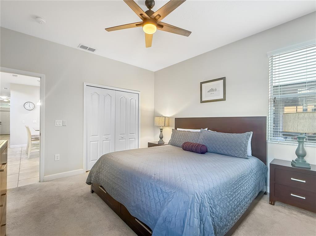 2942 Buccaneer Palm Road Kissimmee, FL 34747 - Photo 18 of 39 a bedroom with a bed and a chandelier