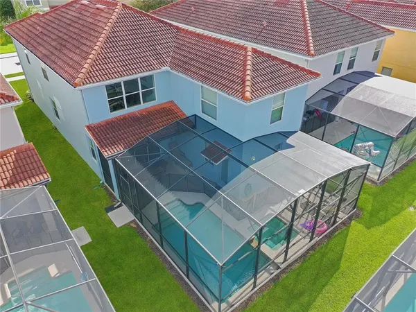 an aerial view of a house with a yard