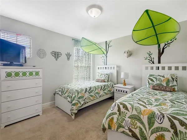 a bedroom with two beds and a window