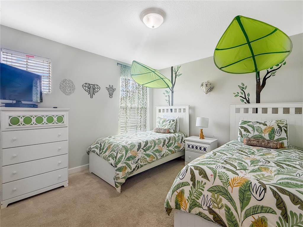 2942 Buccaneer Palm Road Kissimmee, FL 34747 - Photo 23 of 39 a bedroom with two beds and a window
