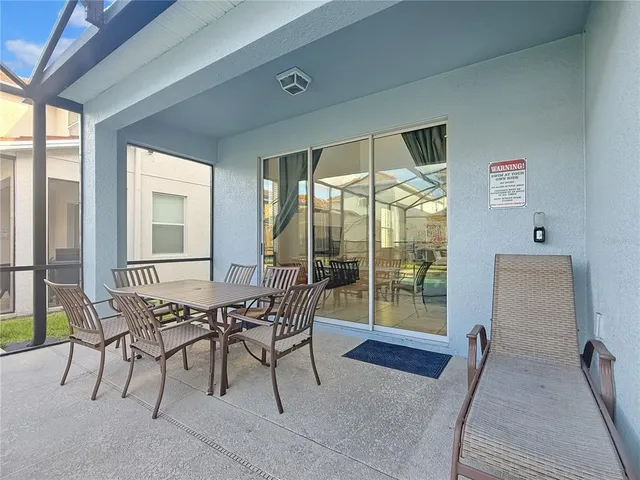 a dining room with furniture and front door