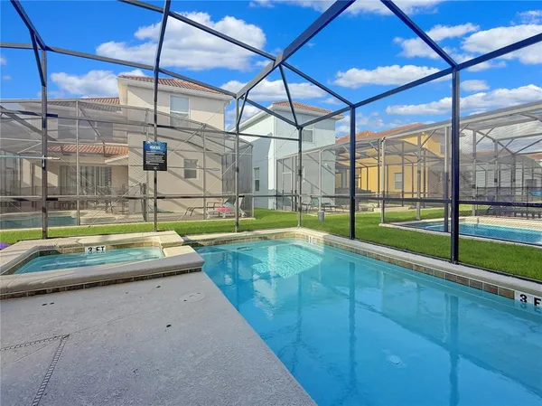 a view of a backyard with a swimming pool