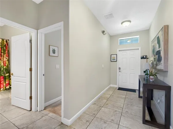 a view of a hallway with bathroom and front door